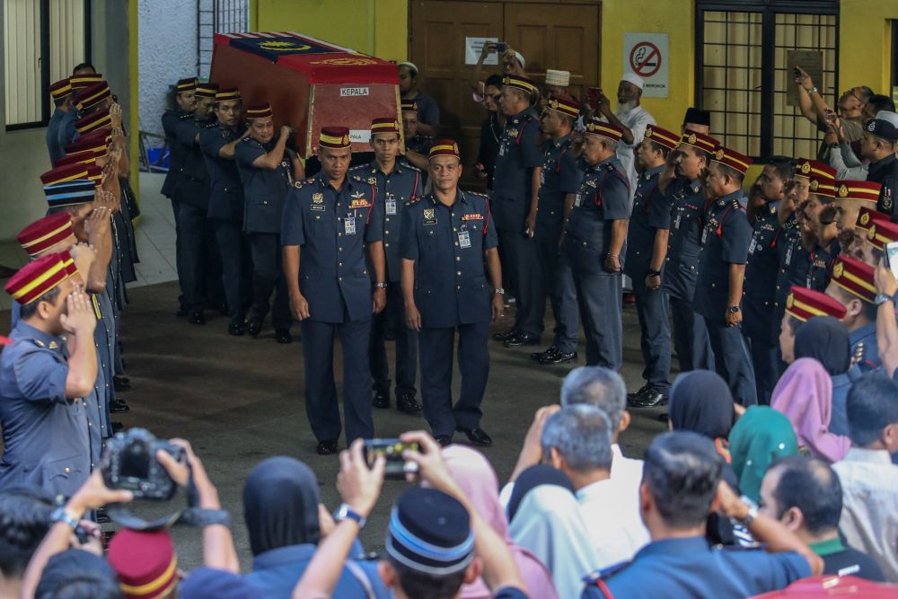 Fire and Rescue Deptment personnel carry Muhammad Adibu00e2u20acu2122s coffin out of the Kuala Lumpur General Hospitalu00e2u20acu2122s Forensic Department, December 18, 2018. u00e2u20acu201d Picture by Hari Anggara