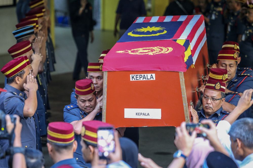 Fire and Rescue Deptment personnel carry Muhammad Adibu00e2u20acu2122s coffin out of the Kuala Lumpur General Hospitalu00e2u20acu2122s Forensic Department, December 18, 2018. u00e2u20acu201d Picture by Hari Anggara