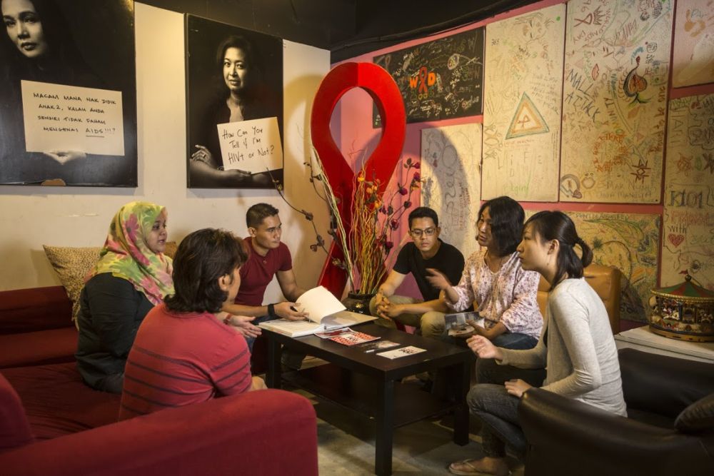 PT Foundation staff and volunteers discuss how to improve their services. — Picture by Ahmad Yusni