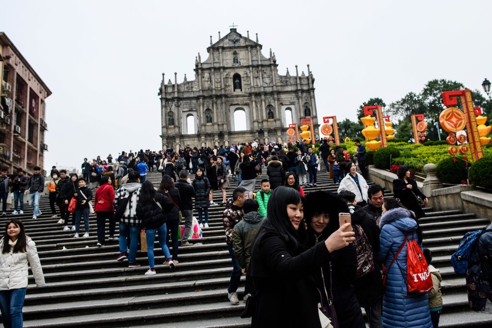 Tourists take a selfie in front of the southern stone facade of the ruins of St Paulu00e2u20acu2122s Church, a 17th-century Portuguese complex in Santo Antonio, in Macau February 2, 2018. u00e2u20acu201d AFP pic