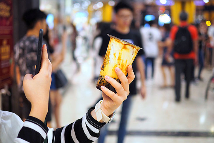 Taking a picture of Taiwan’s popular boba milk drink Tiger Sugar for Instagram.