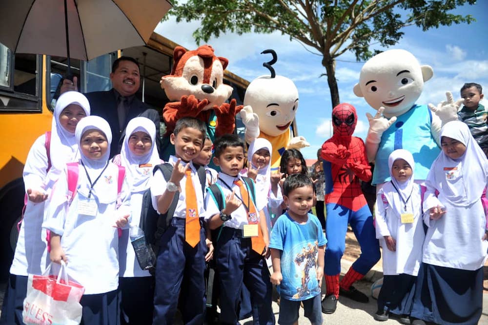 Newly enrolled Year One pupils of SK Taman Scientex in Pasir Gudang pose with the life-sized cartoon characters outside of the schoolu00e2u20acu2122s entrance today. u00e2u20acu201d Picture by Ben Tan