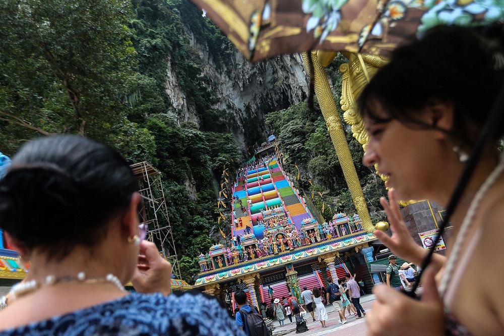 A visitor takes a photograph of the colourful staircase at Batu Caves in Kuala Lumpur August 27, 2018. u00e2u20acu201d Pix by Malaymail/ Hari Anggara. 
