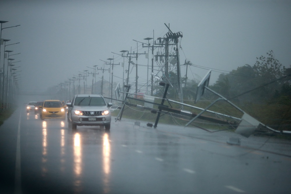 Cars and fallen electricity poles are seen along a road as tropical storm Pabuk approaches the southern province of Nakhon Si Thammarat, Thailand January 4, 2019. u00e2u20acu201d Reuters pic