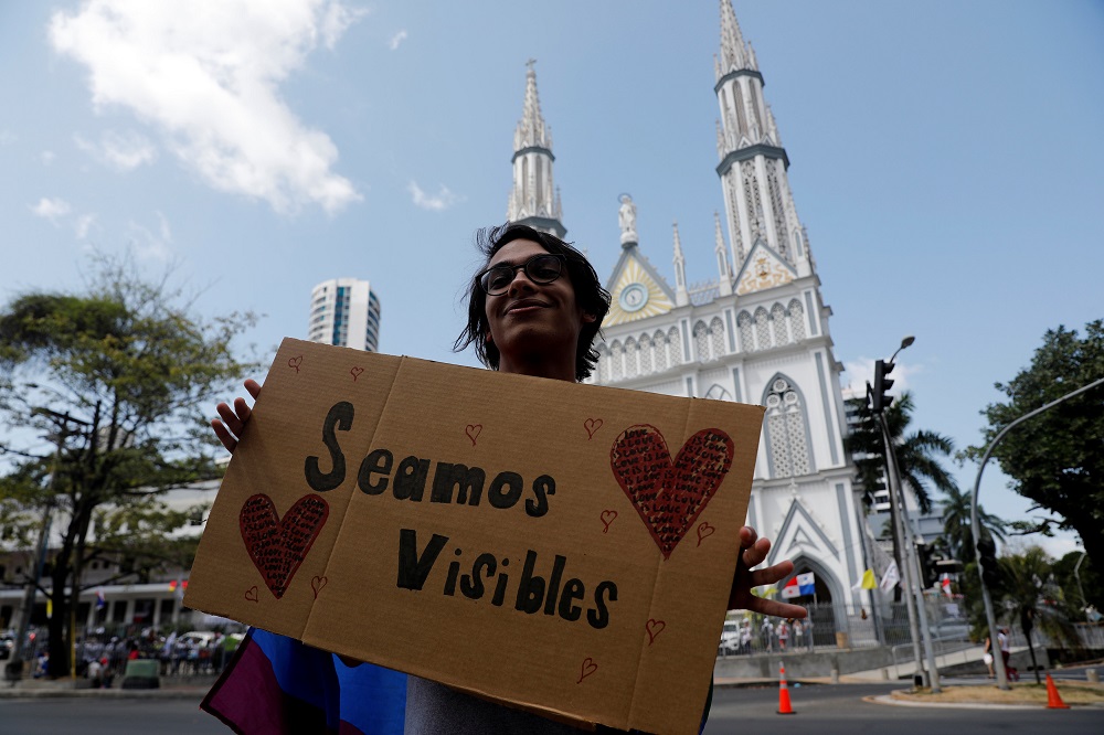 A member of the LGBT community holds a sign reading u00e2u20acu02dcLetu00e2u20acu2122s be visibleu00e2u20acu2122 during a Kissathon to demand equal rights for LGBT on the sidelines of Pope Francis visit to Panama City January 25, 2019. u00e2u20acu201d Reuters picnn n