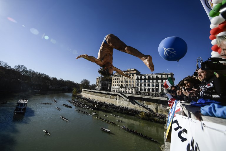 Marco Fois of Italy dives from the Cavour bridge into Rome's river Tiber as part of traditional New Year celebrations on January 1, 2019. u00e2u20acu201d AFP pic