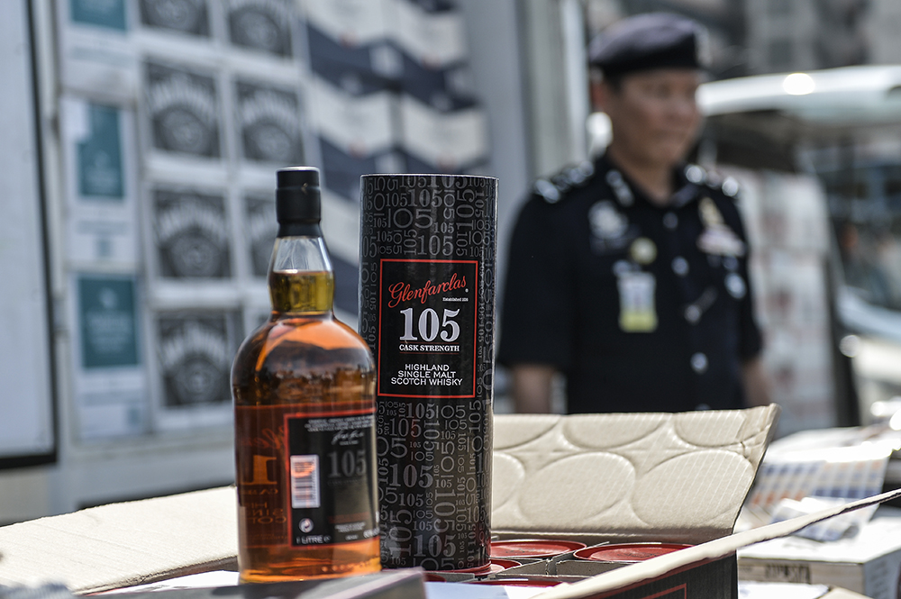One of the liquor bottle seized during the raid is seen during a police press conference in Bukit Jalil January 21, 2019. u00e2u20acu201d Picture by Miera Zulyana