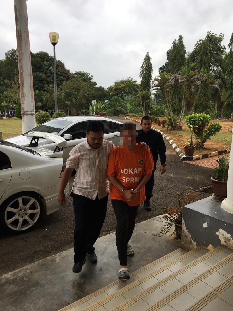 A senior Universiti Teknologi Mara lecturer from the Segamat campus is detained by MACC officers January 27, 2019. u00e2u20acu201d Picture courtesy of the Malaysian Anti-Corruption Commission 