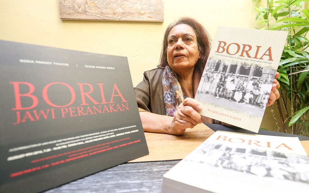 Professor Datuk Wazir Jahan Karim with the book she wrote on boria theatre. u00e2u20acu201d Picture by Sayuti Zainudin