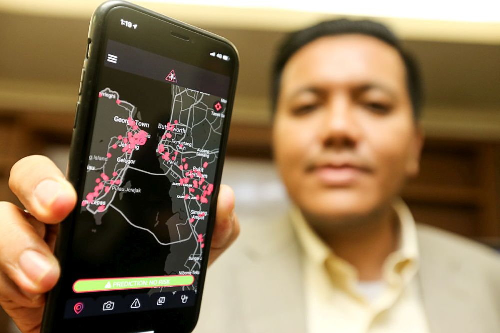 Dr Afif Bahardin displays the Predict and Beat Dengue app on a smartphone during a media conference at Wisma Persekutuan, George Town January 28, 2019. u00e2u20acu201d Picture Sayuti Zainudin