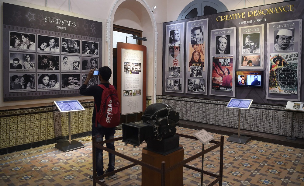 In this picture taken on January 22, 2019, a student takes a picture of a display of former Indian movie actors at the National Museum of Indian Cinema, the countryu00e2u20acu2122s first museum showcasing the history of its film industry in Mumbai. u00e2u20acu201d AFP pic