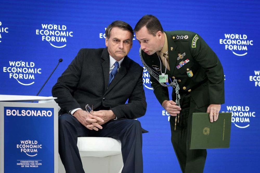 An officer speaks with Brazilian President Jair Bolsonaro (right) prior to his delivering a speech during the World Economic Forum (WEF) annual meeting, on January 22, 2019 in Davos, Switzerland. u00e2u20acu201d AFP pic
