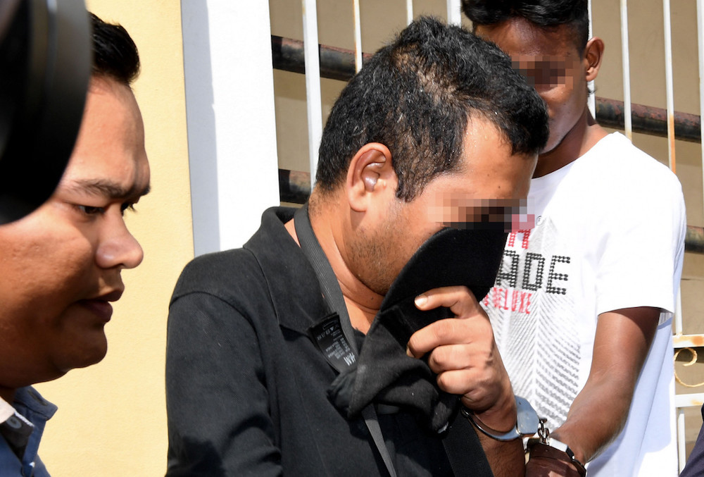A 41-year-old man is brought to the Penang court complex January 7, 2019, to be remanded following accusations of child abuse. u00e2u20acu201d Bernama pic
