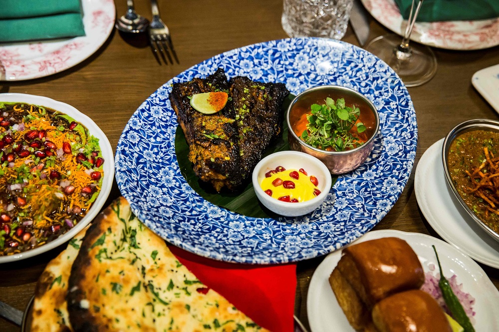 This picture taken on January 16, 2019, shows spiced fish (centre), naan bread and other dishes on display at the New Punjab Club restaurant in Hong Kong. u00e2u20acu201d AFP pic      