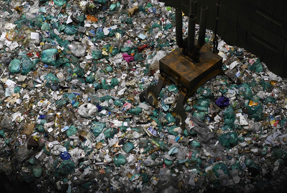 This photo taken on January 18, 2019, shows an enormous crane picking up rubbish for incineration at a combustible waste pit at the Musashino Clean Centre in Tokyo. u00e2u20acu201d AFP pic 