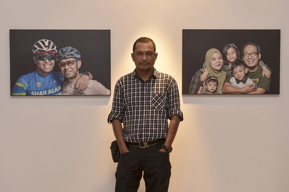 Ahmad Yusni with some of the photographs that he has taken for the Outshine exhibition. — Picture by Mukhriz Hazim