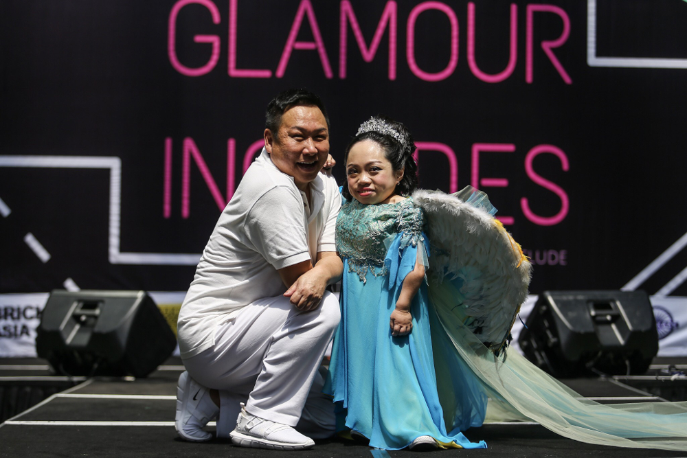 Bill Keith and Rachel Siew strike a pose on the u00e2u20acu02dcGlamour Includesu00e2u20acu2122 catwalk. u00e2u20acu2022 Pictures by Hari Anggara