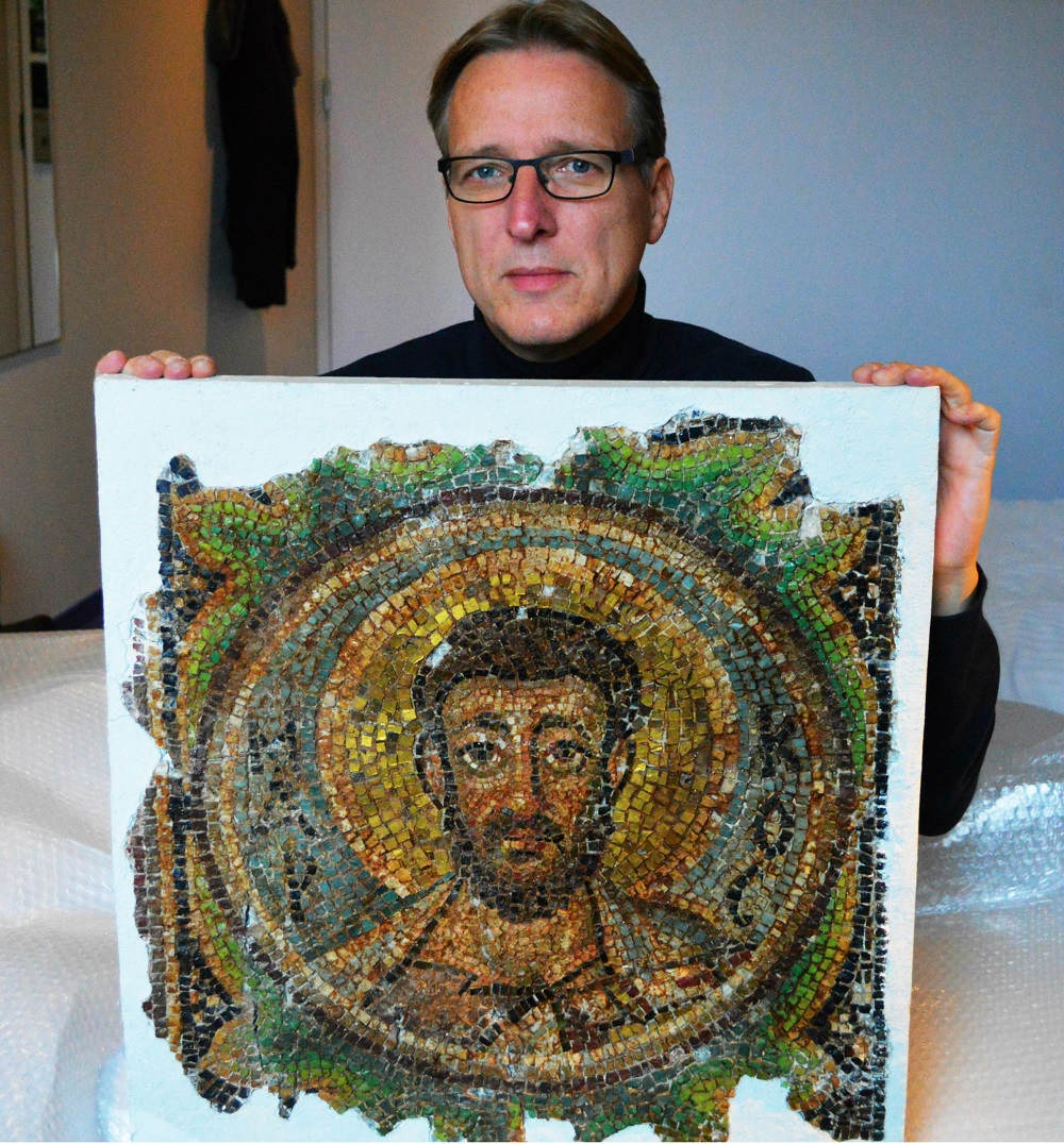Dutch art detective Arthur Brand poses with the missing mosaic of St Mark, a rare piece of stolen Byzantine art from Cyprus, in a hotel room in The Hague November 17, 2018. u00e2u20acu201d AFP pic  