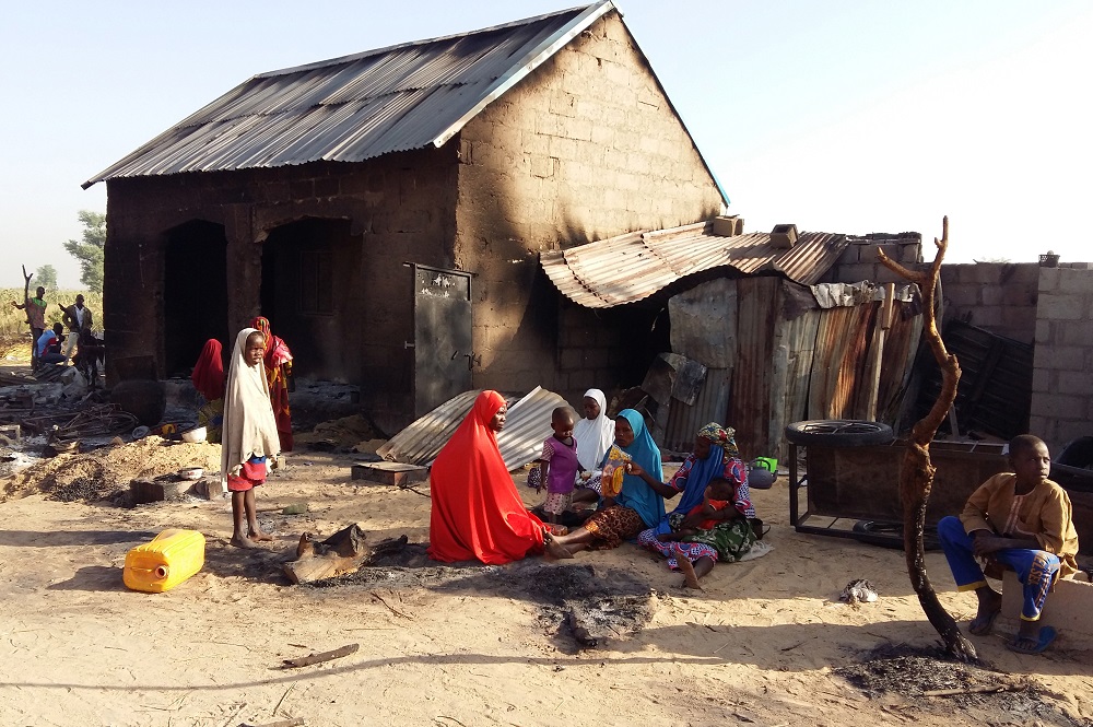 People sit near a burnt house after an attack by suspected members of the Islamist Boko Haram insurgency in Bulabulin village, Nigeria November 1, 2018. u00e2u20acu201d Reuters pic     