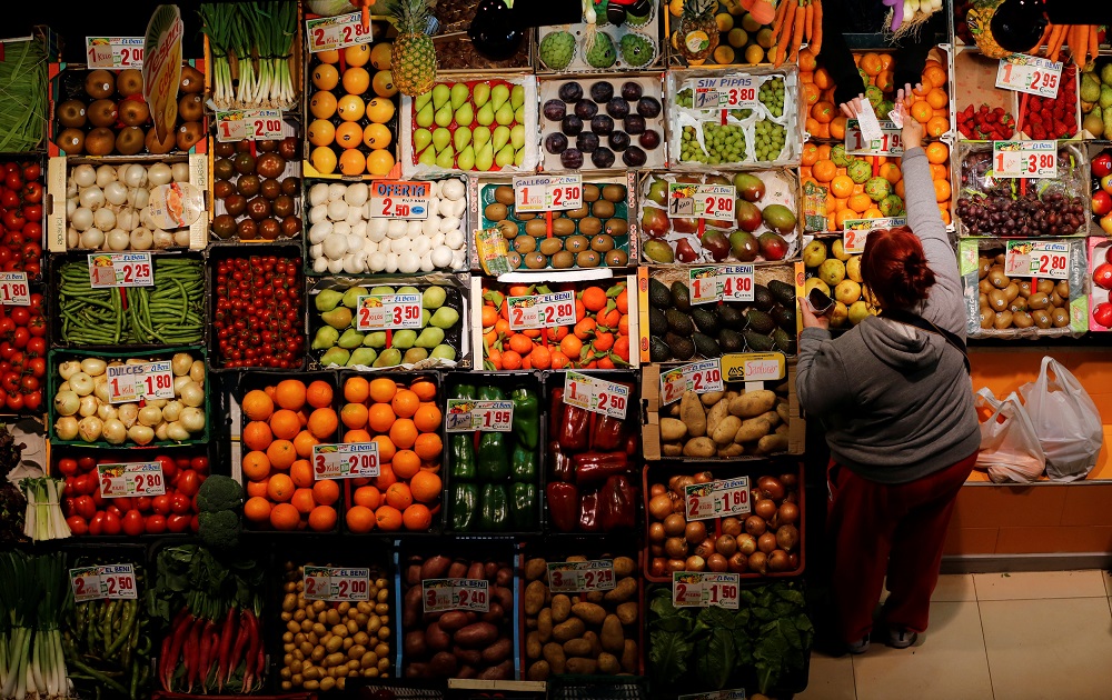 A woman shops at a fruits and vegetables shop at a food market in the Andalusian capital of Seville, southern Spain March 7, 2016. u00e2u20acu201d Reuters pic     