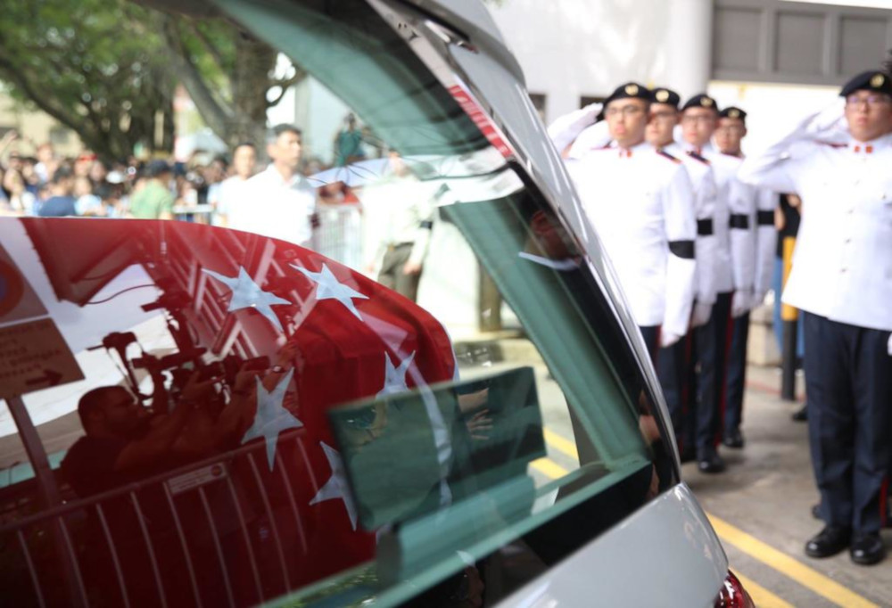 Pall-bearers at MacPherson Lane saluting the coffin of late actor Aloysius Pang. u00e2u20acu201d TODAY pic