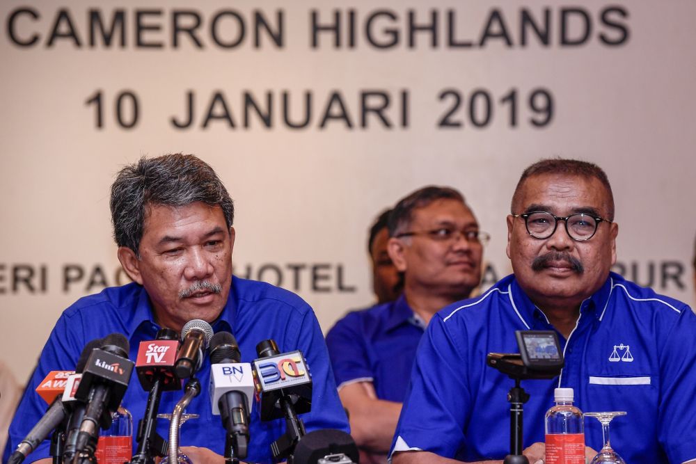 BN deputy chairman Datuk Seri Mohamad Hasan speaks during a press conference at the Seri Pacific Hotel Kuala Lumpur as Cameron Highlands candidate Ramli Mohd Noor looks on. u00e2u20acu201d Picture by Hari Anggaran