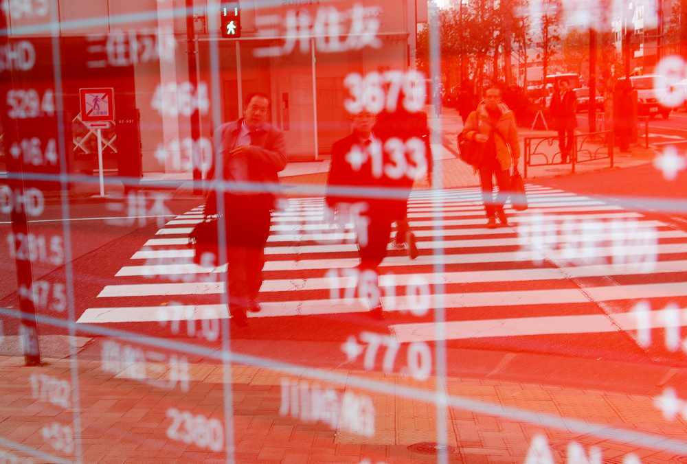Pedestrians are reflected on an electronic board showing stock prices outside a brokerage in Tokyo, Japan December 27, 2018. u00e2u20acu201d Reuters pic