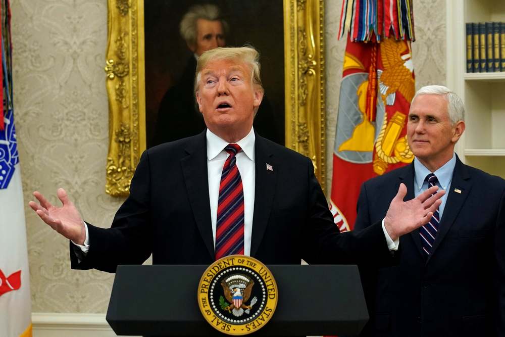 US President Donald Trump reacts as he speaks next to Vice President Mike Pence looks during a Naturalisation Ceremony in the Oval Office of the White House in Washington, January 19, 2019. u00e2u20acu201d Reuters pic