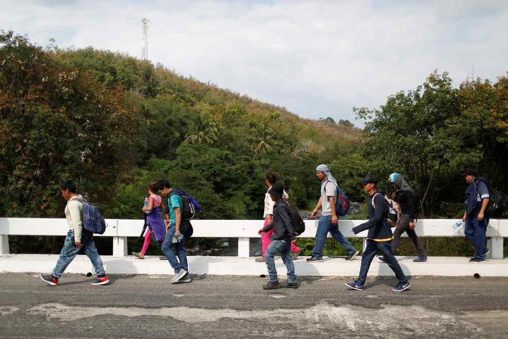 People belonging to a caravan of migrants from El Salvador en route to the United States, walk along a highway on their way to Ciudad Tecun Uman, Guatemala from Nuevo San Carlos, Guatemala January 16, 2019. u00e2u20acu201d Reuters pic 