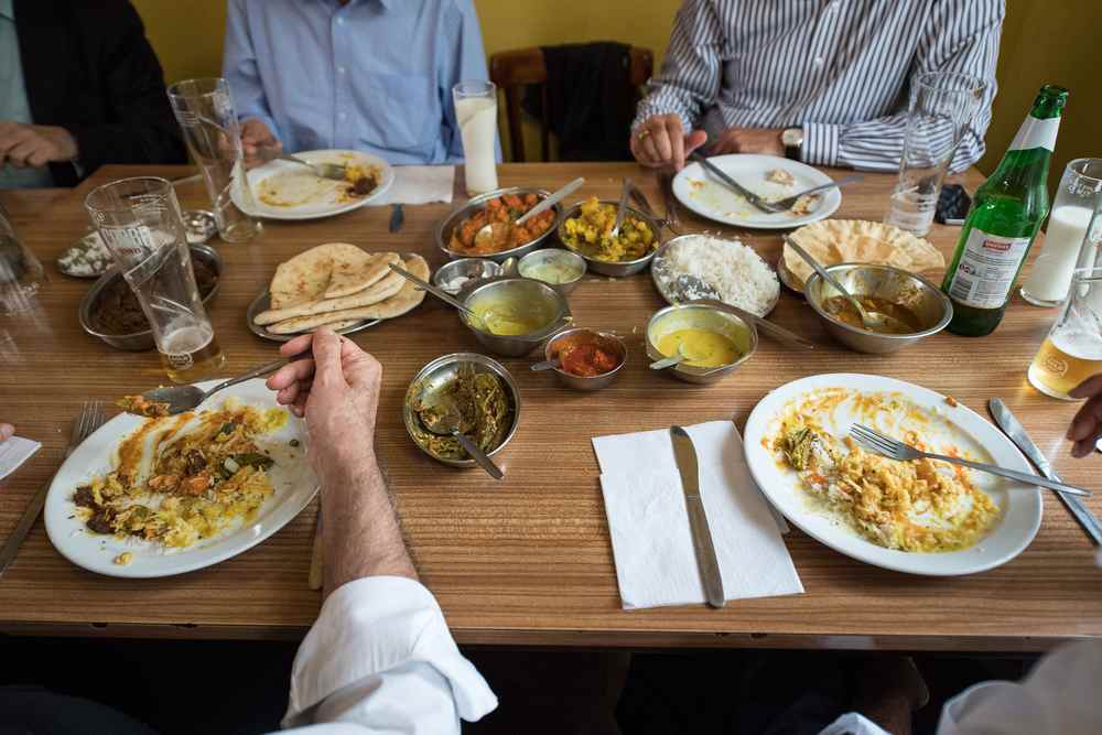 People eat lunch inside the India Club restaurant in London. u00e2u20acu201d AFP pic