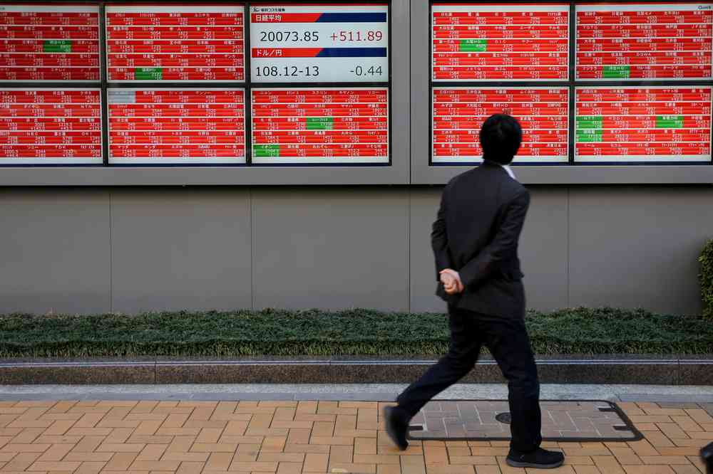 A man looks at an electronic board showing the Nikkei stock index outside a brokerage in Tokyo, Japan January 7, 2019. u00e2u20acu201d Reuters pic