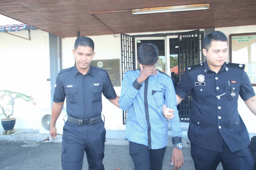The boy being led out of the Kampar Magistrates Court after the proceeding on January 14, 2019. u00e2u20acu201d Picture by Sylvia Looi