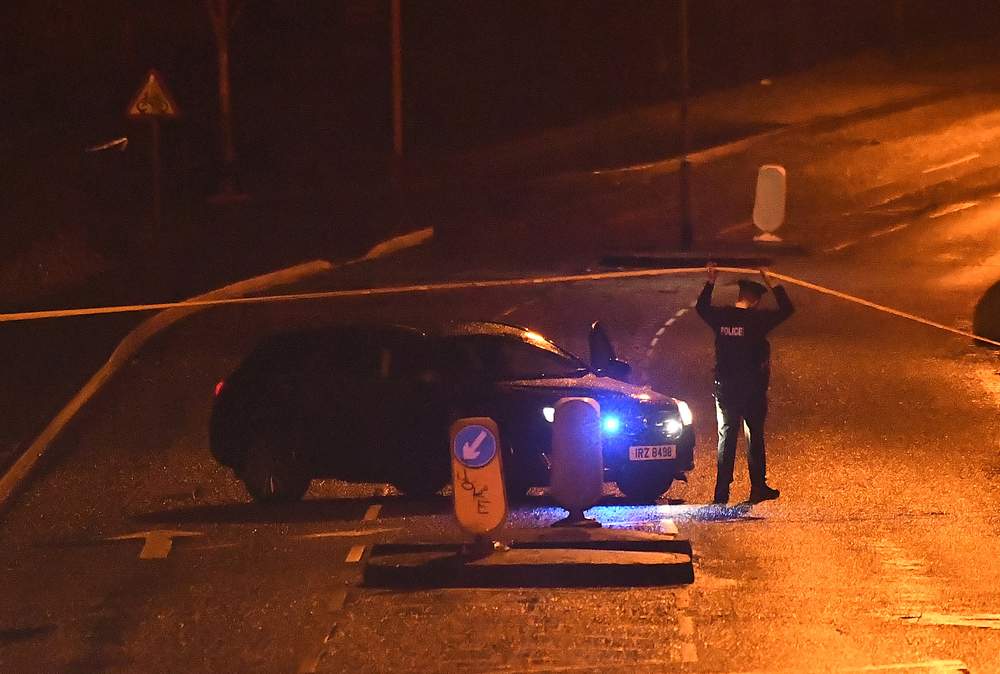 A police officer stands near a police vehicle while adjusting a cordon around an abandoned suspect vehicle (unseen) at the scene of a security alert in Northland, Londonderry, Northern Ireland January 21, 2019. u00e2u20acu201d Reuters pic