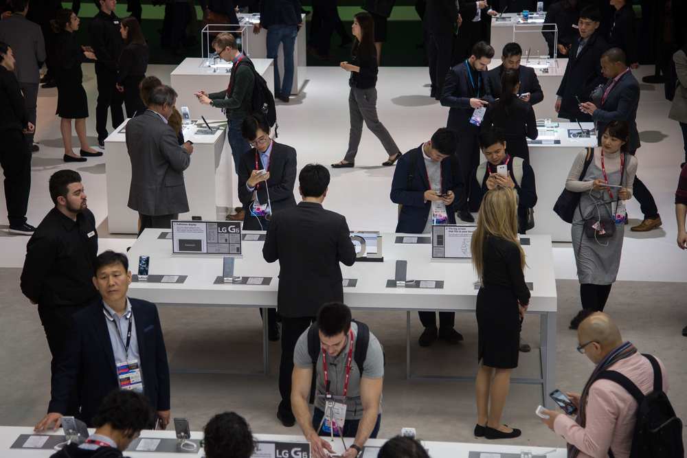 Visitors testing various LG devices at the company's booth during the 2017 Mobile World Congress. Will the brand bring a dual screen device to this year's event? u00e2u20acu201d AFP pic