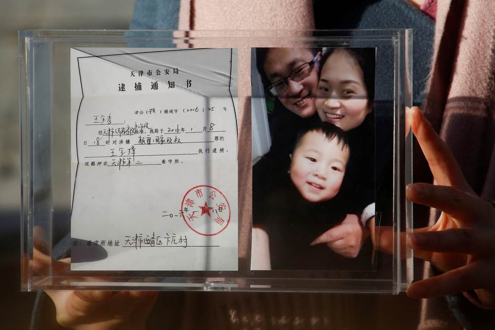 Li Wenzu, the wife of prominent Chinese rights lawyer Wang Quanzhang, holds a box with a family picture and the detention notice for her husband before shaving her head in protest in Beijing December 17, 2018. u00e2u20acu201d Reuters pic