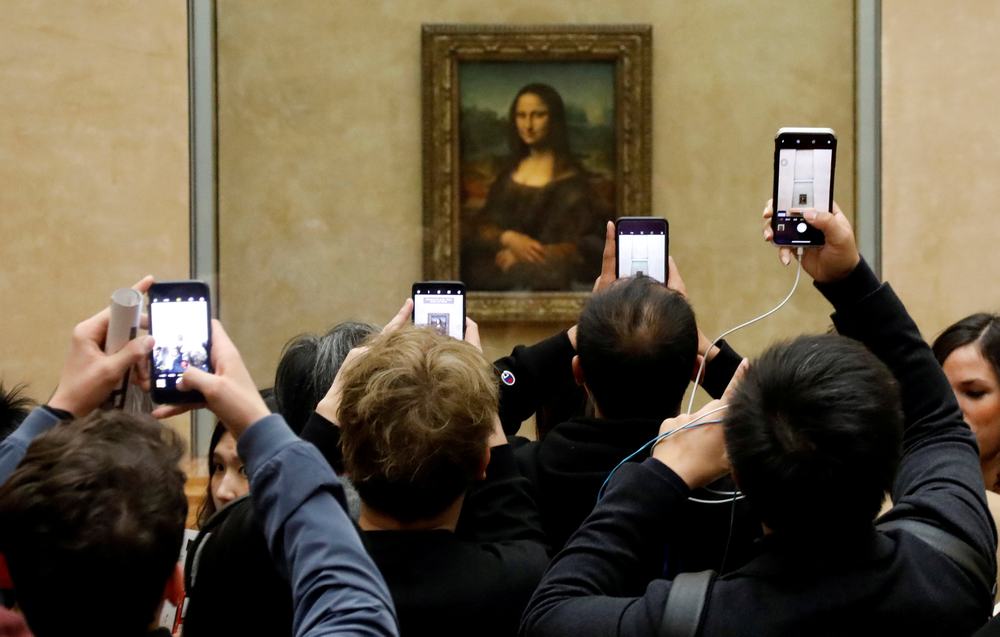 Visitors take pictures of the painting 'Mona Lisa' (La Joconde) by Leonardo Da Vinci at the Louvre museum in Paris December 3, 2018. u00e2u20acu201d  Reuters pic
