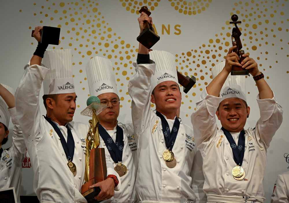 Members of the Malaysian team (from left) Situ Chi Yin, Ming Ai Lol, Wei Loon Tan and Otto Tay celebrate with their trophy after winning the World Pastry Cup final on January 28, 2019 in Chassieu, outside Lyon. u00e2u20acu201d AFP pic