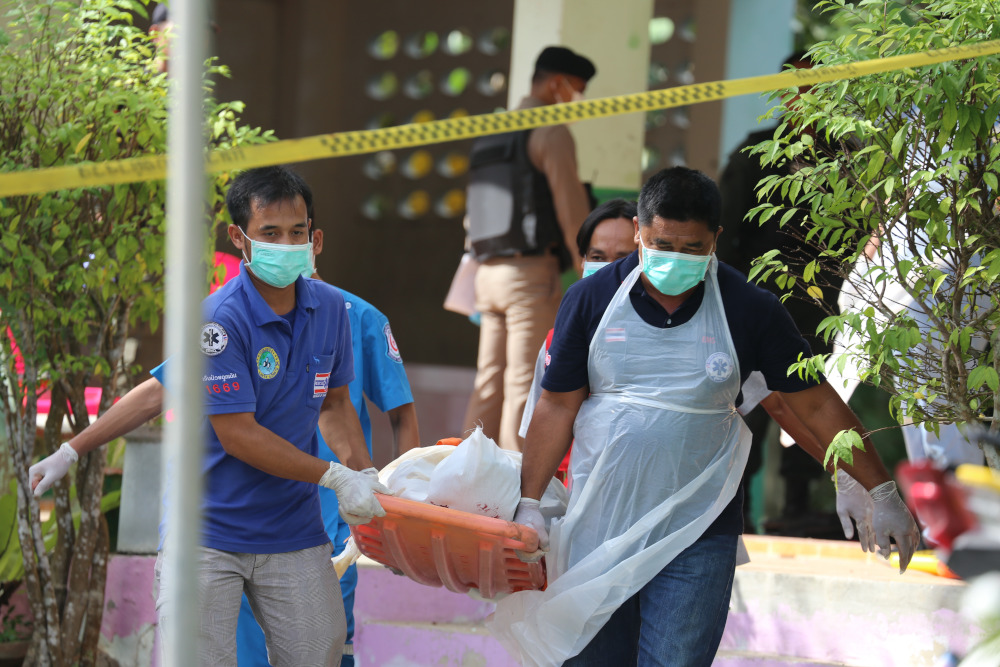 Paramedics take away a body after four Thai civil defence volunteers shot and killed outside of a school in the restive southern province of Pattani on January 10, 2019. u00e2u20acu201d AFP pic 