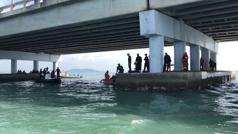 SAR teams found the car near pillar number 34 under Penang Bridge. u00e2u20acu201d Picture by Opalyn Mok