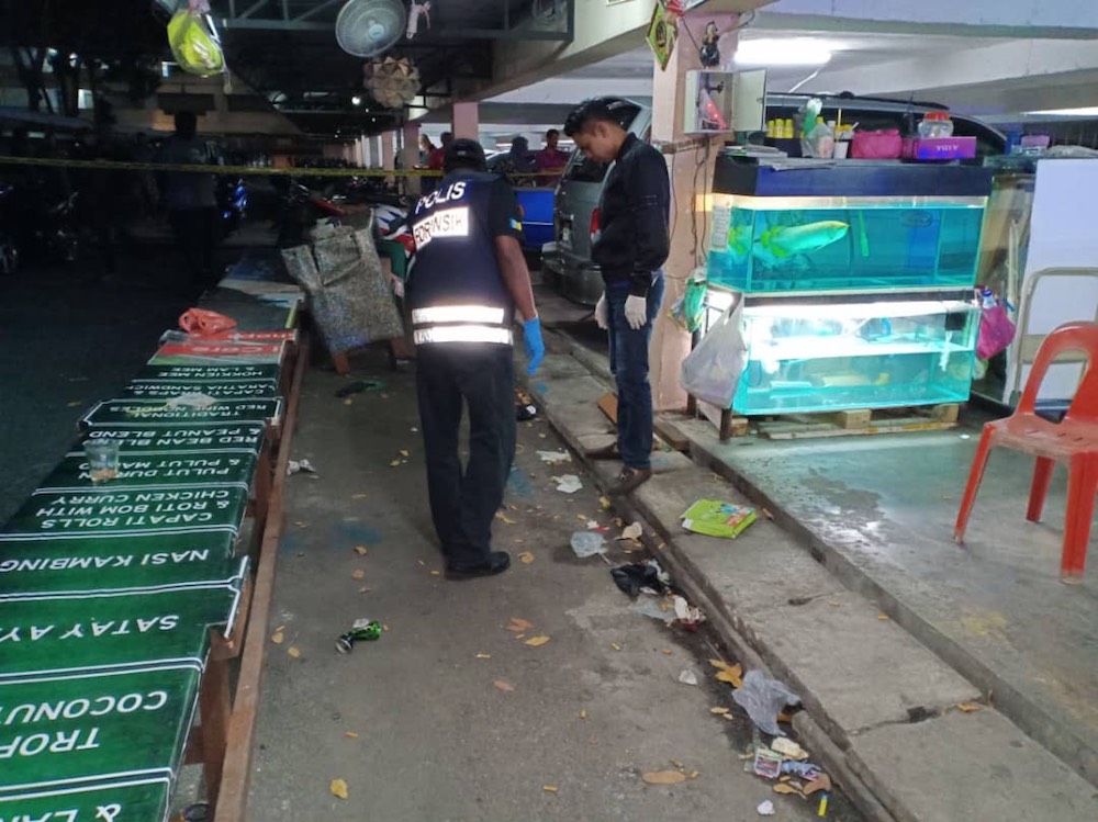 Police conduct investigations at the scene of the shooting at the Jalan Sungai Pinang flats in George Town January 13, 2018. u00e2u20acu201d Picture courtesy of PDRM