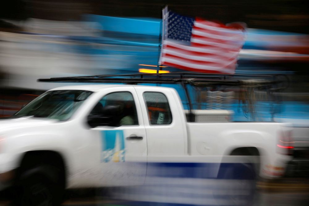 A PG&E truck carrying an American Flag drives past other trucks in Paradise, California November 21, 2018. u00e2u20acu201d Reuters pic