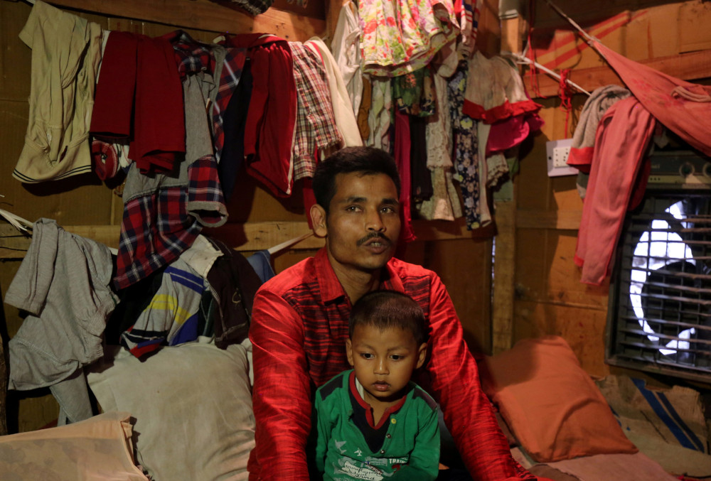 Sahidullah, a man from the Rohingya community, holds his son on his lap as he speaks with Reuters inside his shack at a camp on the outskirts of Jammu October 5, 2018. u00e2u20acu201d Reuters pic 