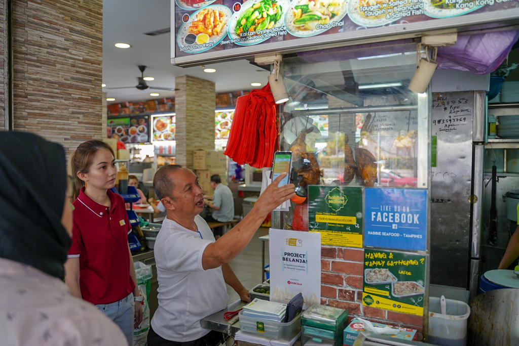 Staff of Habibie Seafood, at the coffee shop of Block 829 Tampines Street 81, demonstrating the seamless claiming process. u00e2u20acu201d TODAY pic