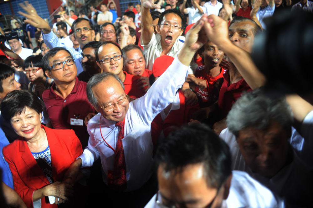 This file photo taken on August 28, 2011 shows Singaporean presidential candidate Tan Cheng Bock (second left) greeting his supporters as he waits for the results of the presidential elections at Jurong east Stadium in Singapore. u00e2u20acu201d AFP pic 