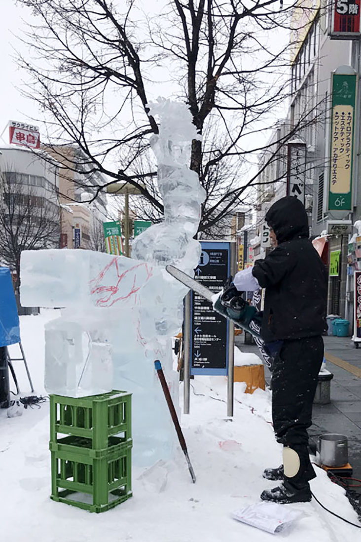 Contestants dress in thick layers to stay warm while they saw away at large blocks of ice.