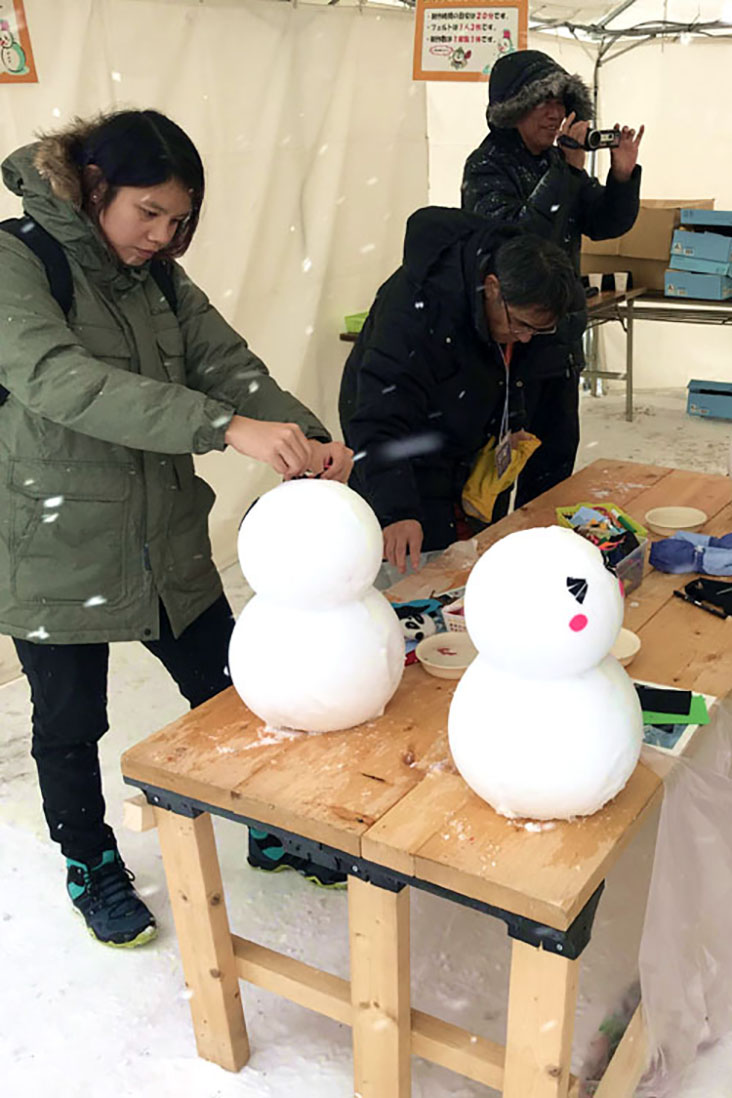 Making snow miniatures inside a tent.