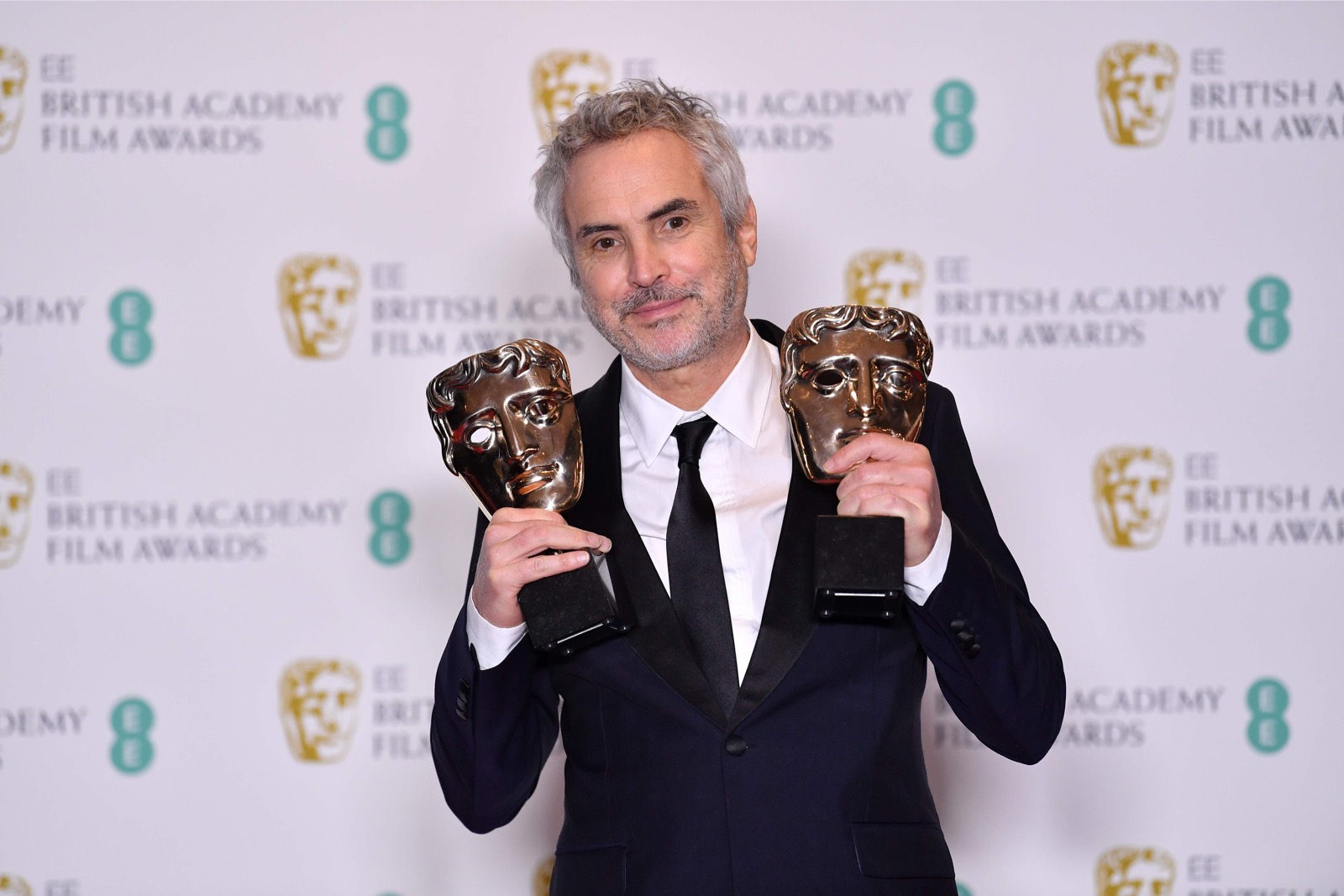 Mexican director Alfonso Cuaron poses with the awards for a Director and for Best Film for 'Roma' at the Bafta British Academy Film Awards at the Royal Albert Hall in London February 11, 2019. u00e2u20acu201d AFP pic