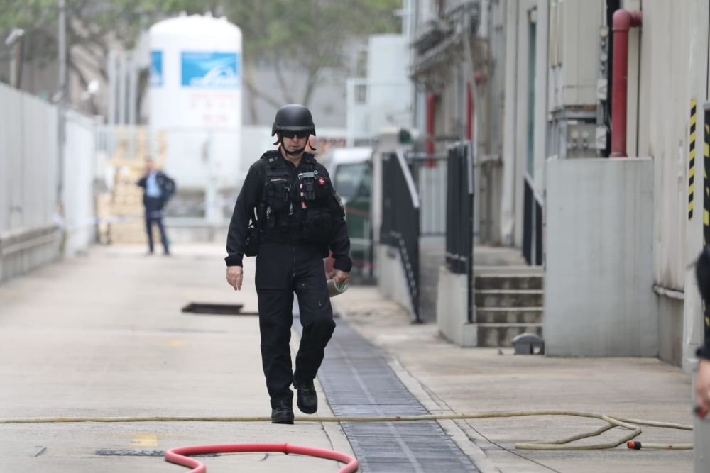 A Hong Kong police officer walks near a drainage channel where the grenade was detonated. u00e2u20acu201d Picture from Facebook/Hong Kong Police