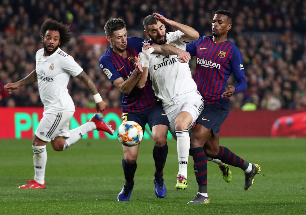 Real Madridu00e2u20acu2122s Karim Benzema in action with Barcelonau00e2u20acu2122s Clement Lenglet and Nelson Semedo during their Copa del Rey semi-final first leg match at Camp Nou in Barcelona February 6, 2019. u00e2u20acu201d Reuters pic