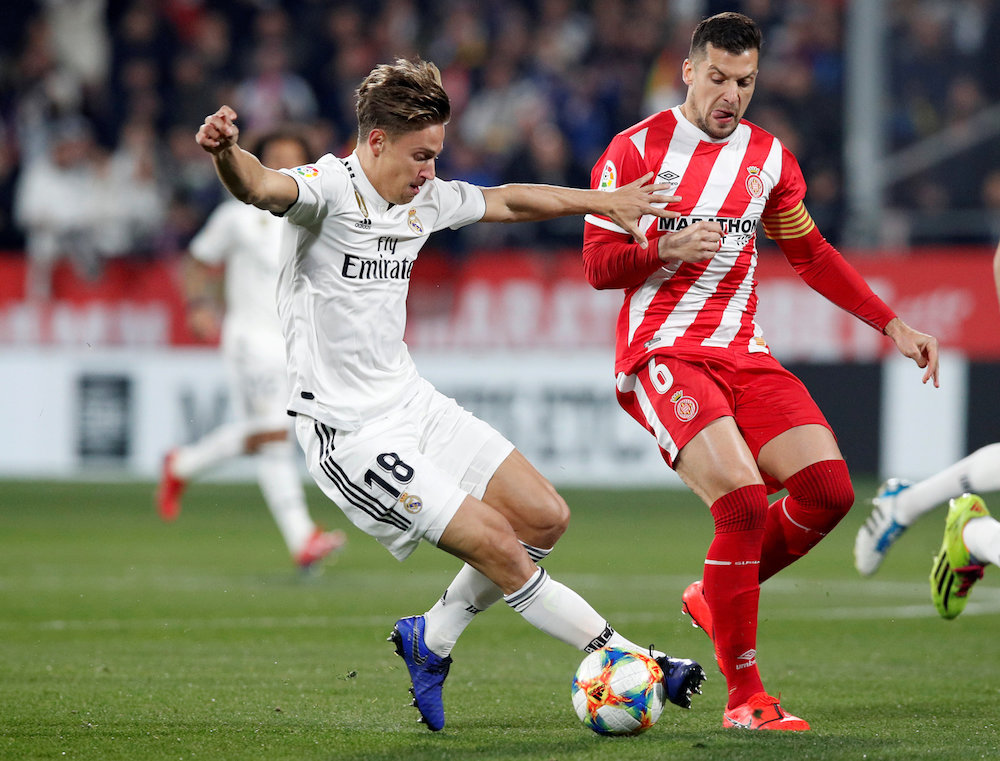 Real Madridu00e2u20acu2122s Marcos Llorente in action with Gironau00e2u20acu2122s Alex Granell during their La Liga match at Montilivi in Girona January 31, 2019. u00e2u20acu201d Reuters pic